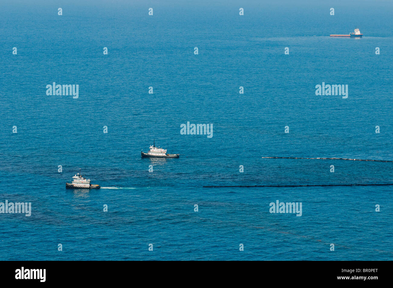 Oil skimming boats collecting oil three miles north of the source MC 252 site, Gulf of Mexico, USA. Stock Photo