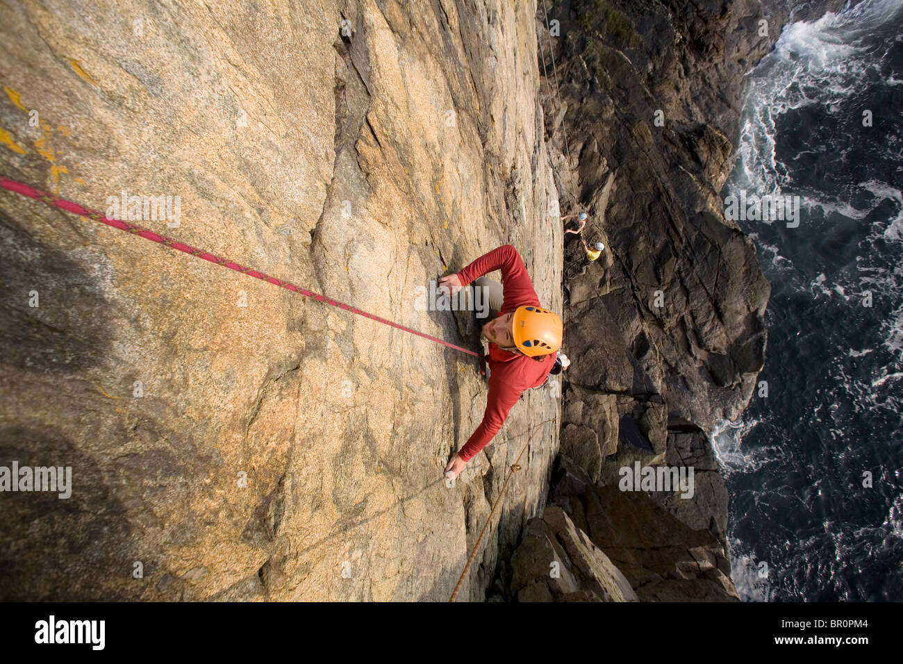 Rock Climbing on oceanside cliffs Stock Photo Alamy