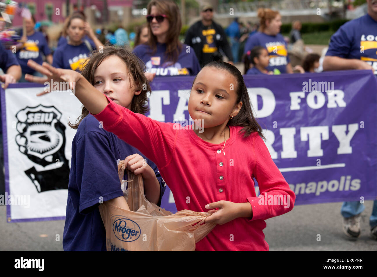 Indianapolis, Indiana Two girls throw candy to spectators during the