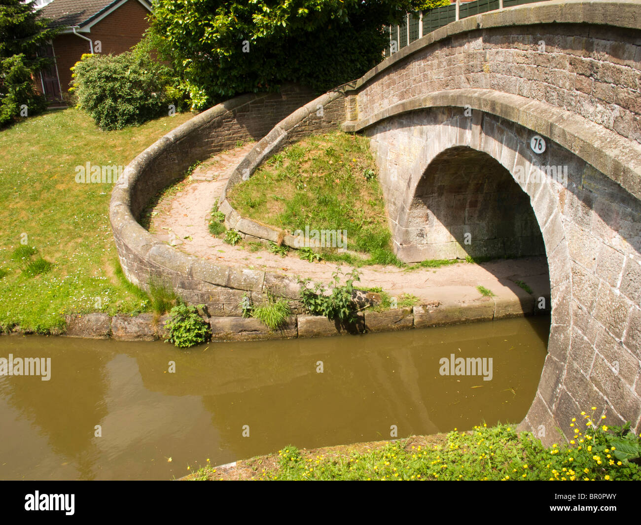 UK, England, Cheshire, Congleton, Macclesfield canal, bridge with curved path to allow horses to change towpath Stock Photo