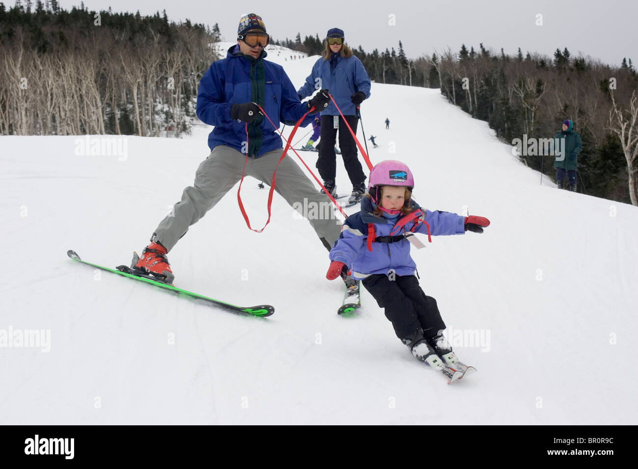 A young girl learns to ski with her family at Sunday River in Bethel, Maine. Stock Photo
