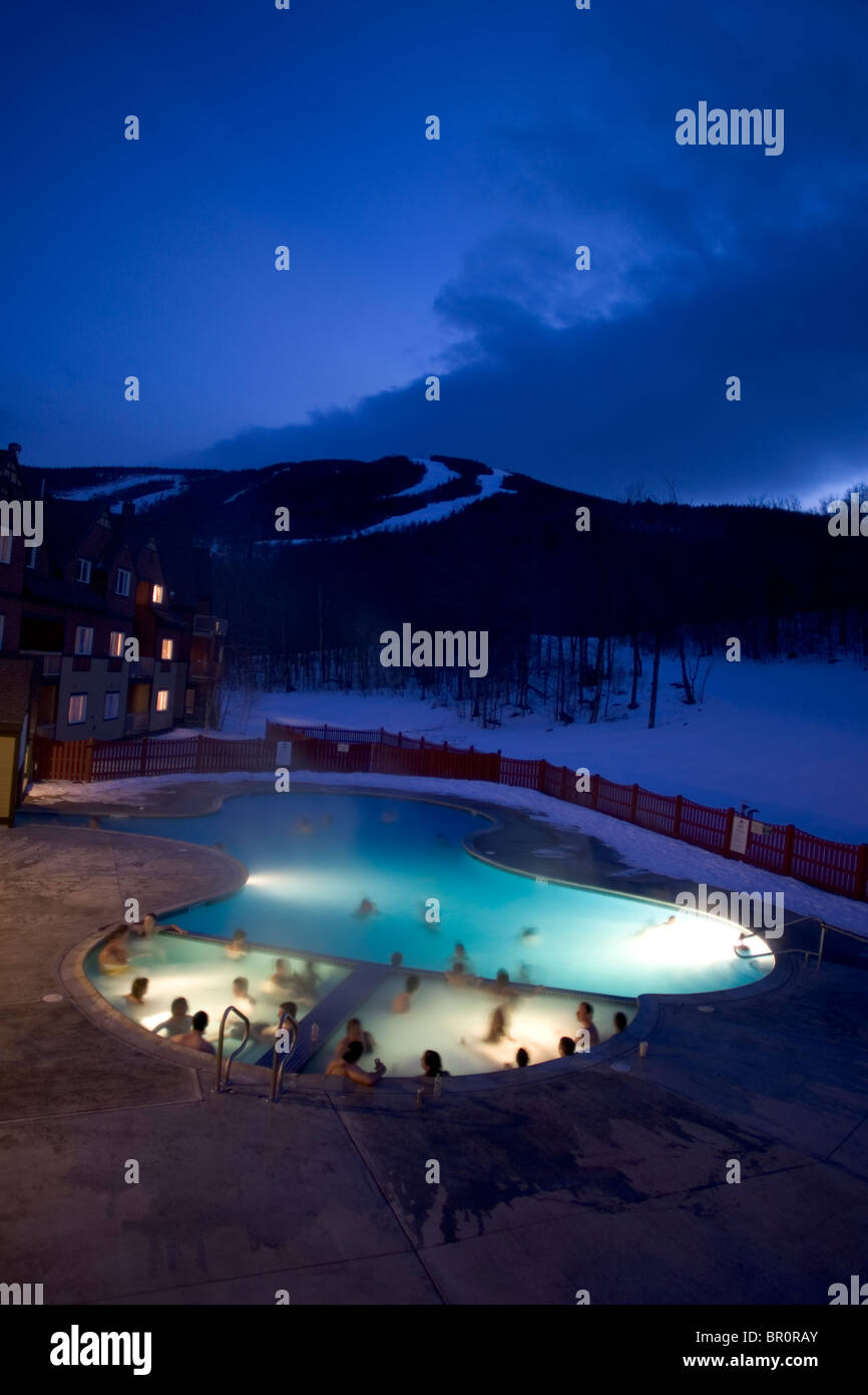 Skiers relax in a heated pool and hot tub at a hotel at Sunday River