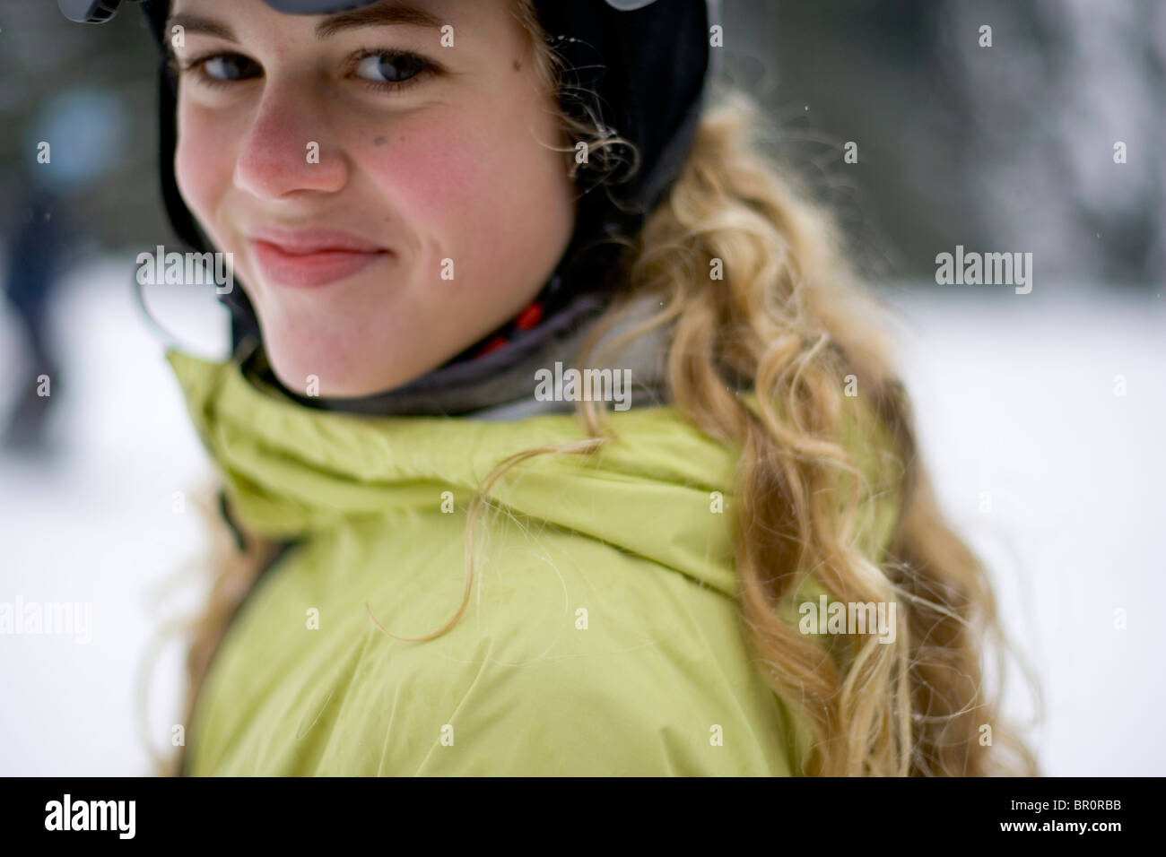 A young woman on vacation snowboarding at Sunday River ski resort in Bethel, Maine. Stock Photo