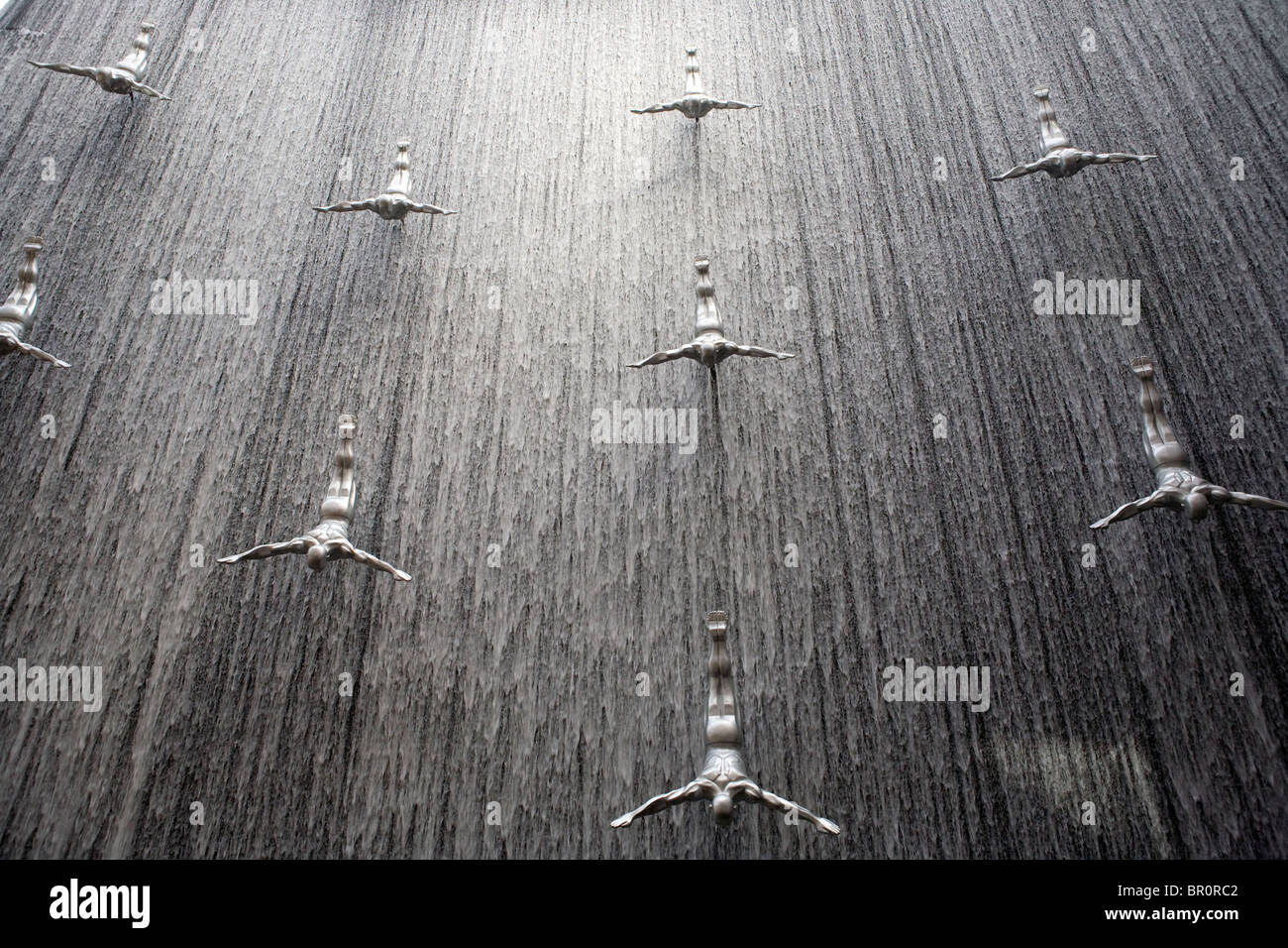 Waterfall With Art Sculptures Of Human Diving Inside The Shopping