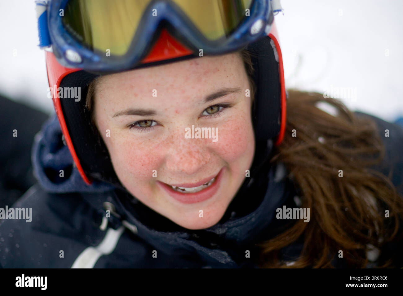 A young woman on vacation snowboarding smiles at Sunday River ski resory in Bethel, Maine. Stock Photo