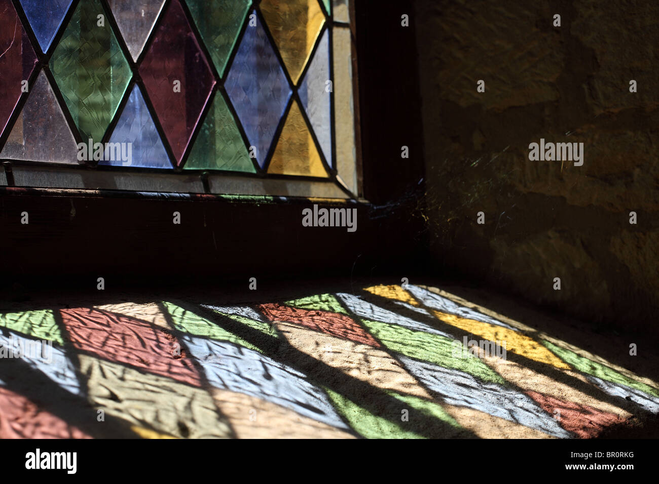 https://c8.alamy.com/comp/BR0RKG/reflected-light-through-colored-glass-window-BR0RKG.jpg