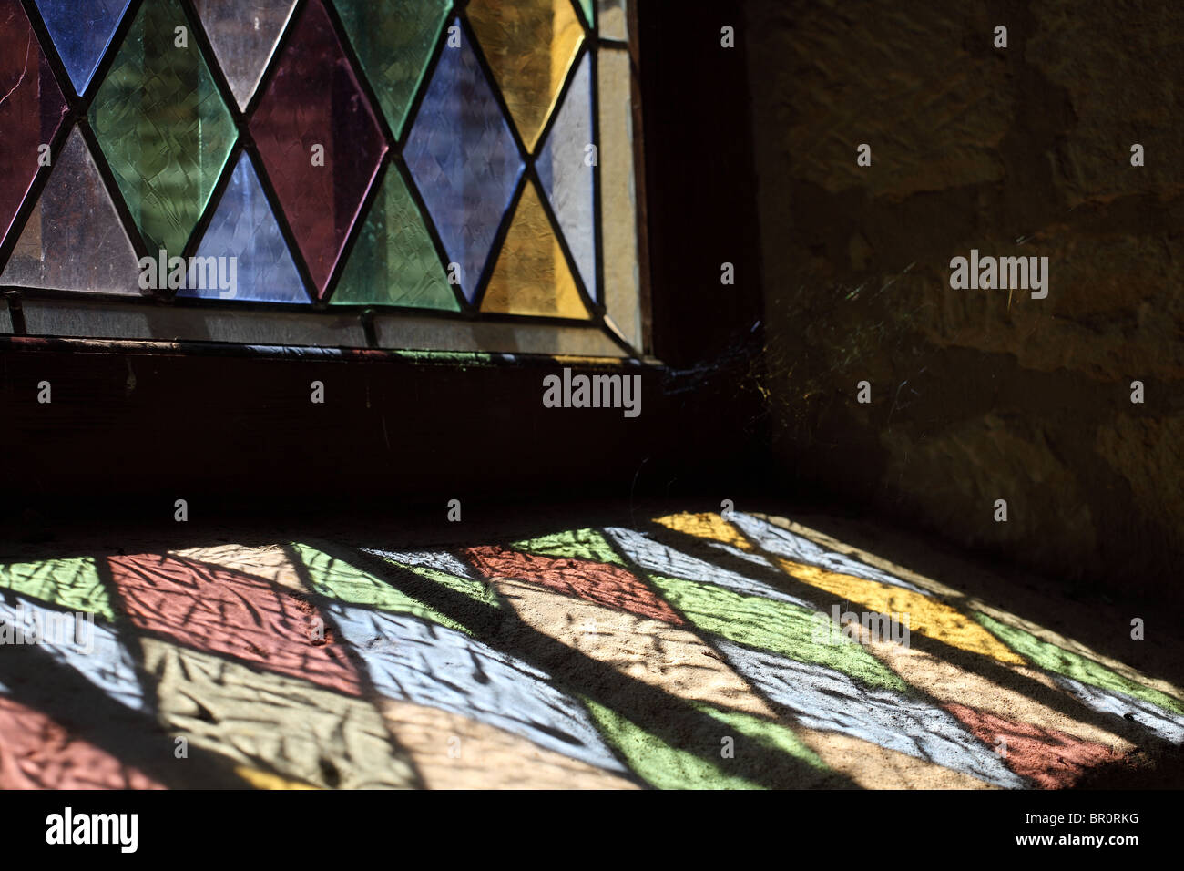 reflected light through colored glass window Stock Photo Alamy