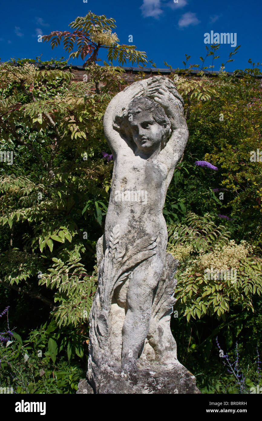 A Statue in an English Country Garden Stock Photo Alamy