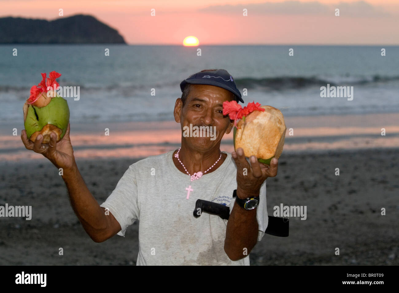 Man selling tropical drinks on the beach at sunset in the Manuel Antonio National Park in Puntarenas province, Costa Rica. Stock Photo