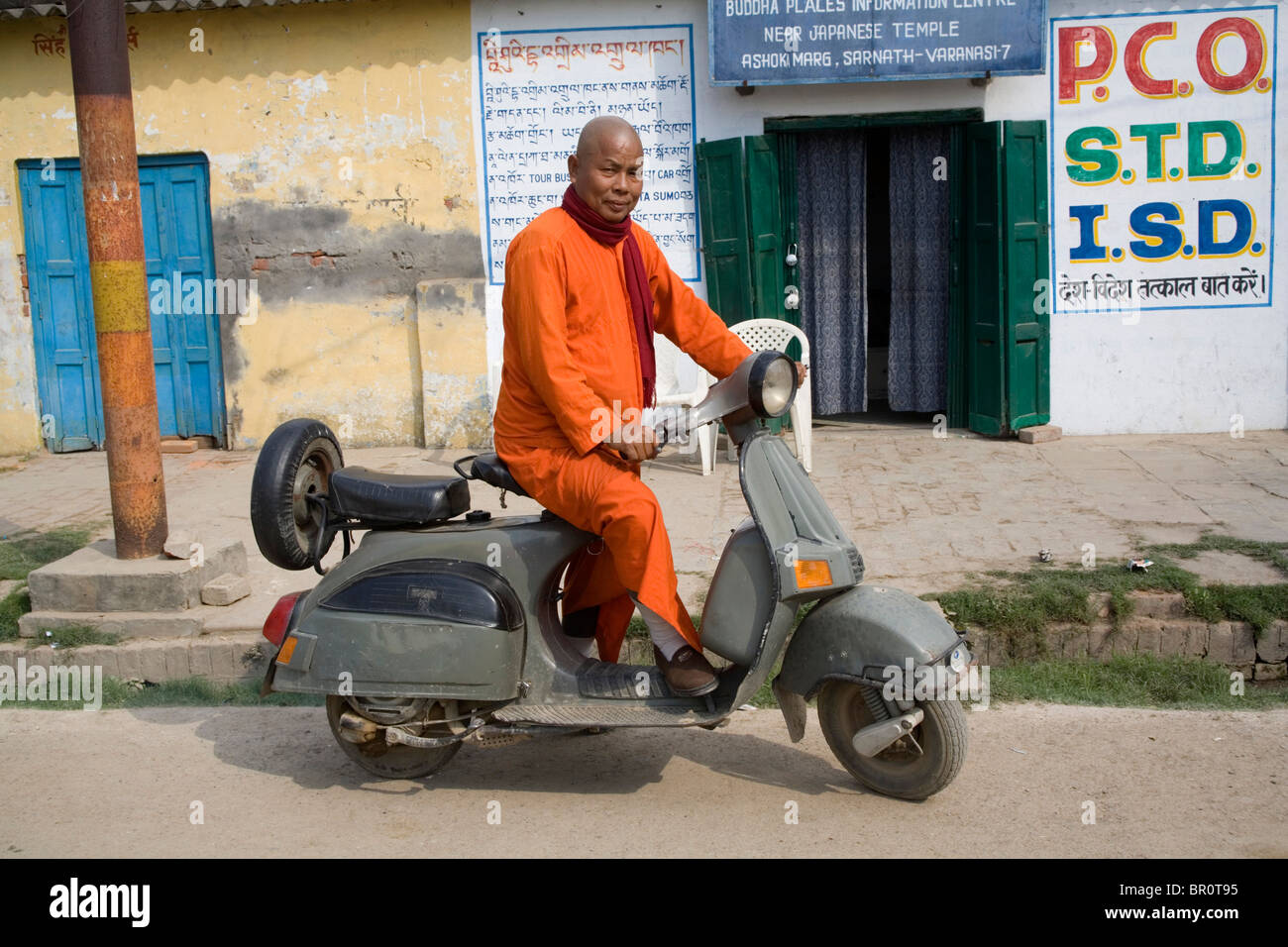 Korean Buddhist monk on his Bajaj scooter the Indian Vespa, Sarnath, Bihar, India. Stock Photo