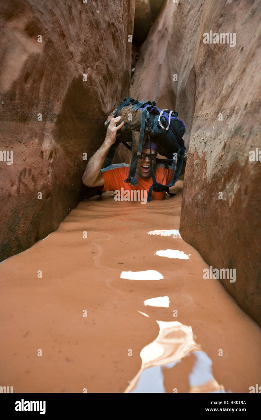A man wading through water in narrow canyon, Utah Stock Photo Alamy