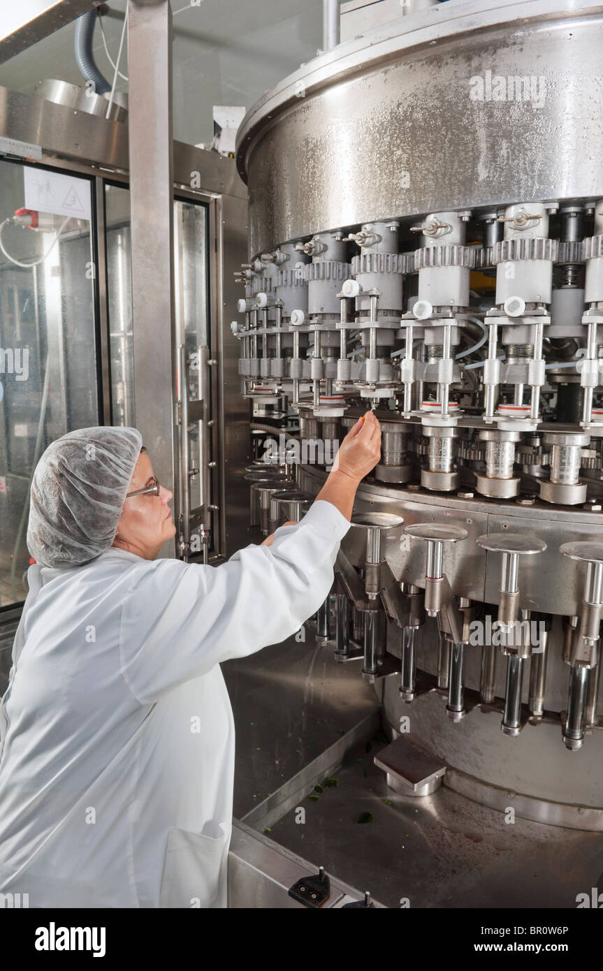 Quality control woman collecting wine sample in Adega Cooperativa de