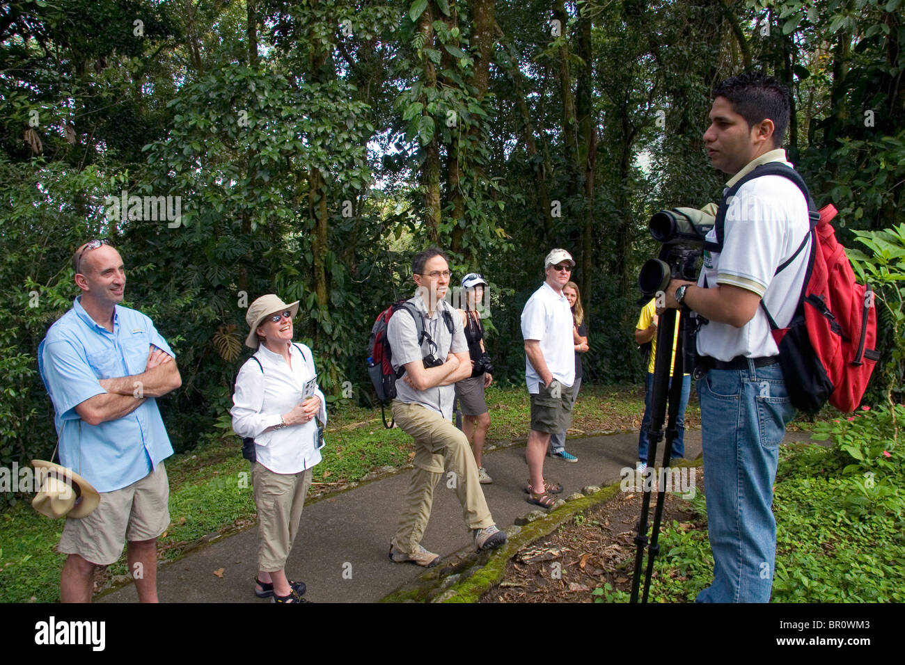 Naturalist guide talking to a group of birdwatchers in the Arenal Volcano National Park near La Fortuna, San Carlos, Costa Rica. Stock Photo
