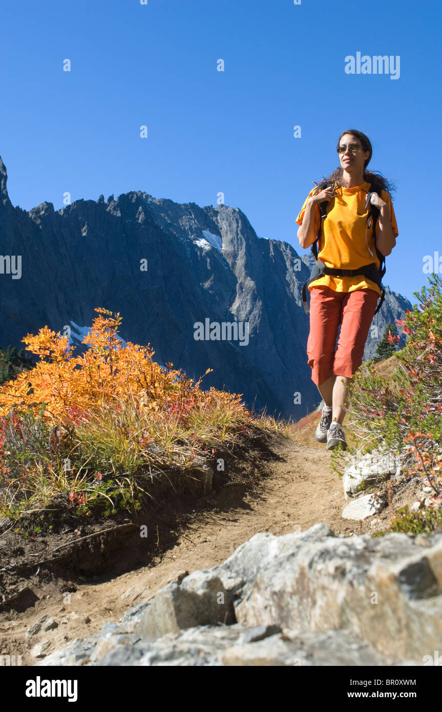 Woman hiking on mountain trail with autumn colors Stock Photo - Alamy