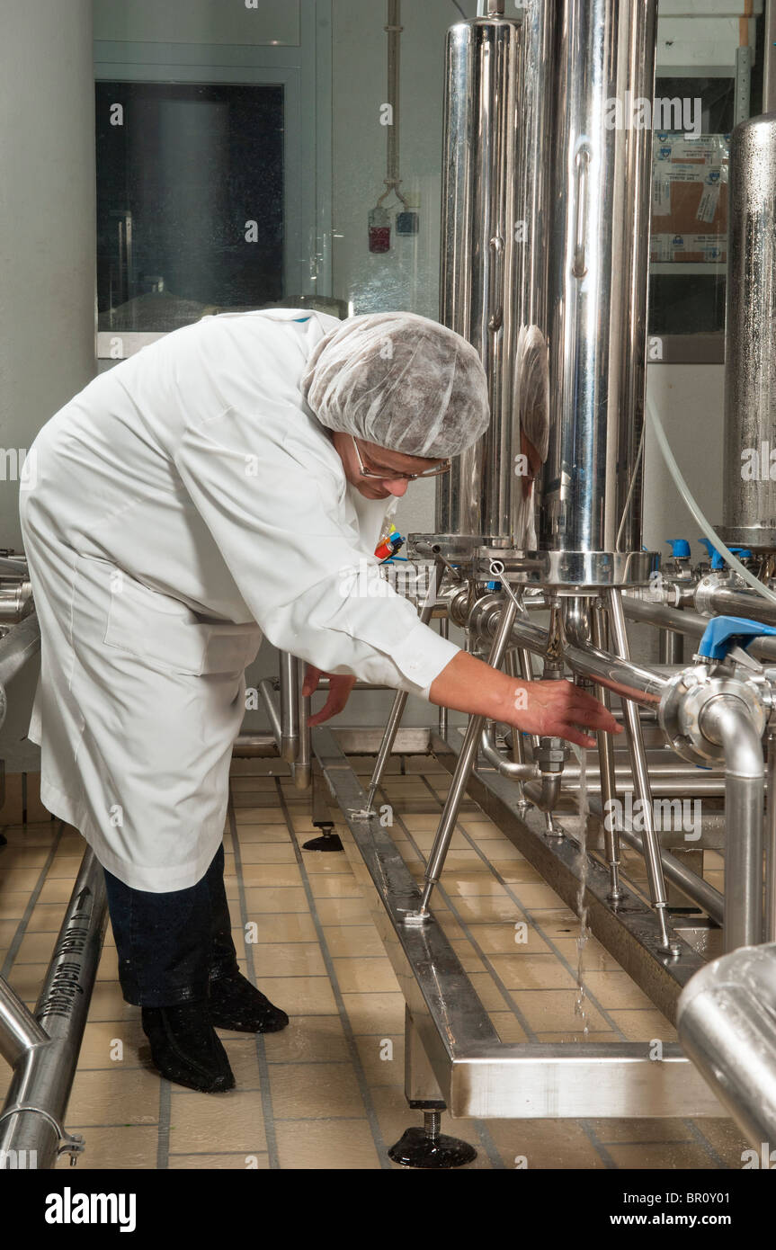 Quality control woman collecting wine sample in Adega Cooperativa de