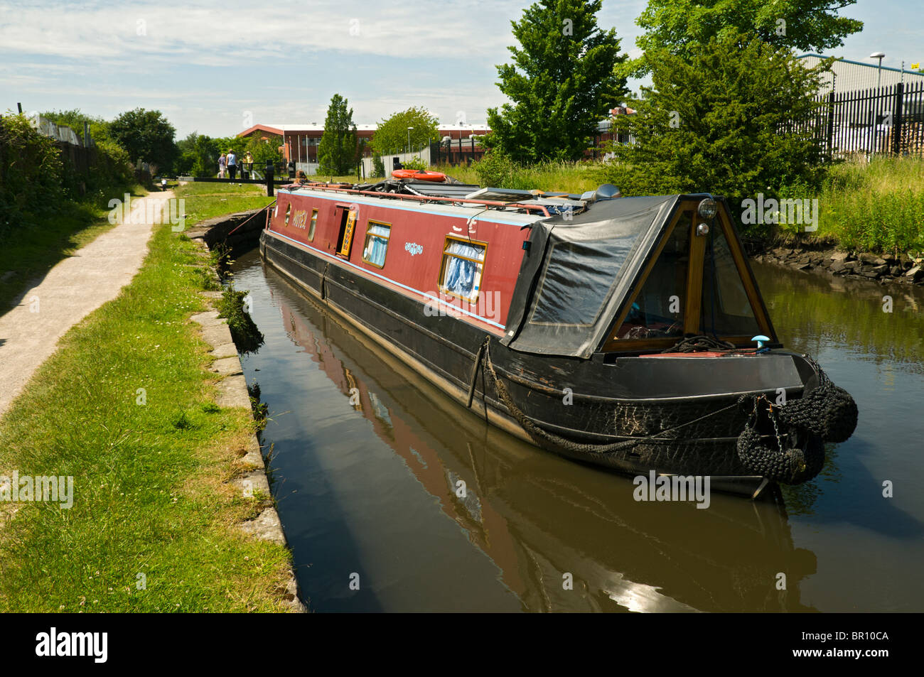 A canal narrowboat going through a lock on the Ashton Canal in Droylsden, Tameside, Manchester, England, UK Stock Photo