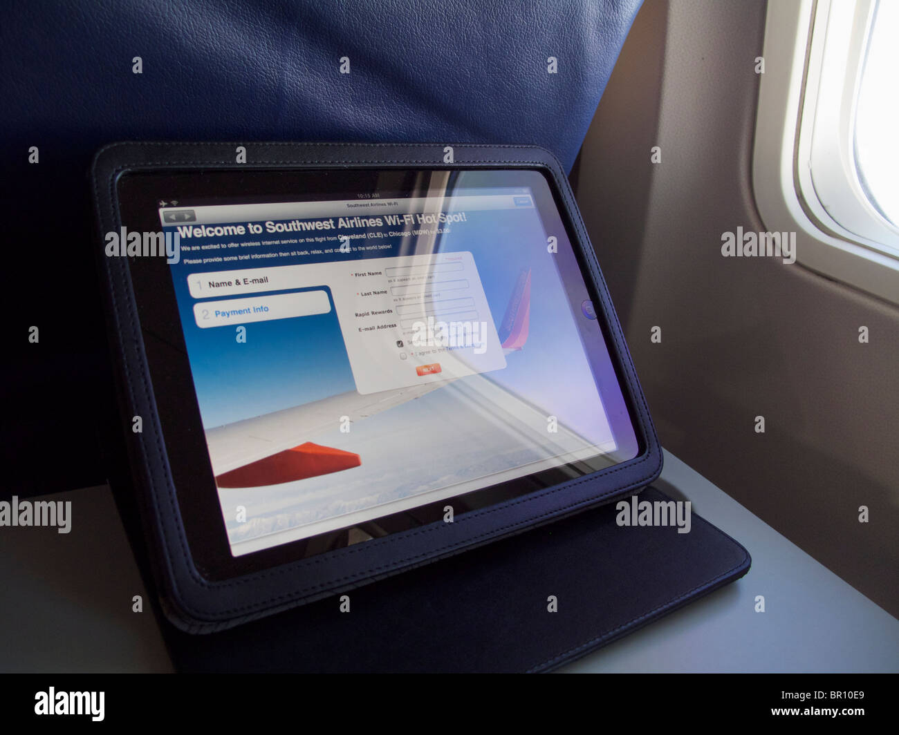Apple iPad on airliner tray table with screen displaying wifi
