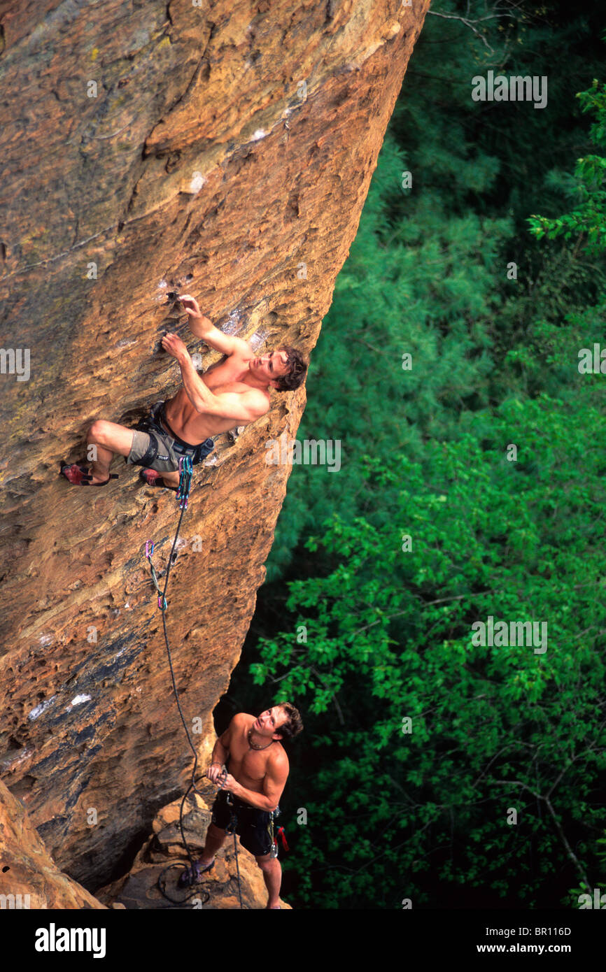 Two men rock climbing on sandstone in a Kentucky forest. Stock Photo