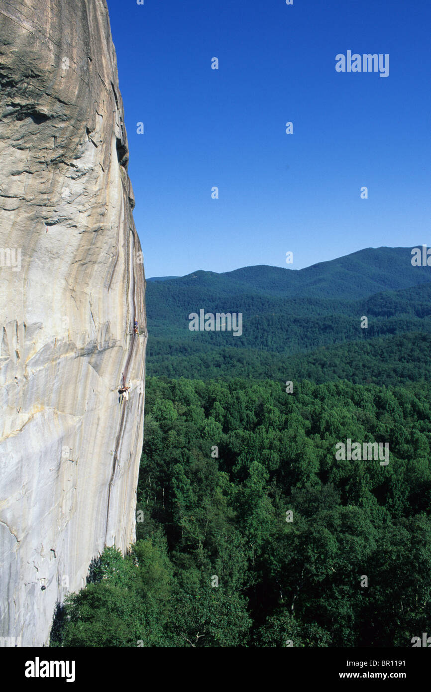 Two men rock climbing on a large granite face in North Carolina. Stock Photo