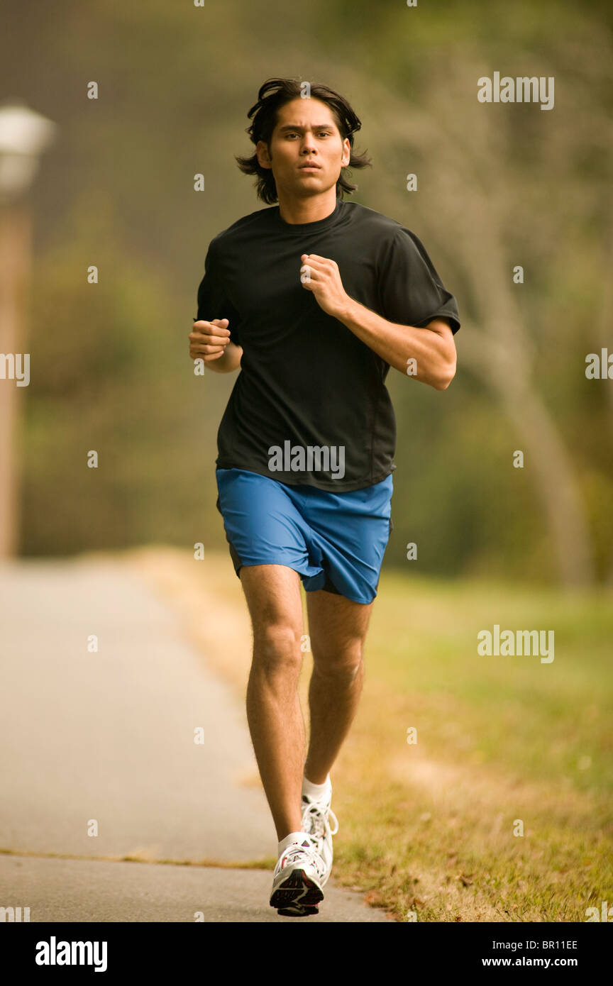 Man jogging on sidewalk Stock Photo
