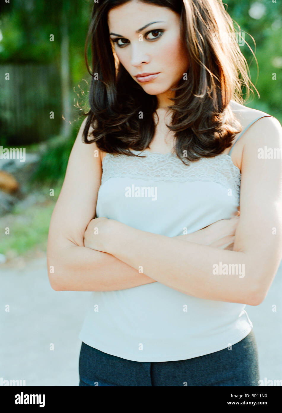 Woman standing with arms crossed Stock Photo