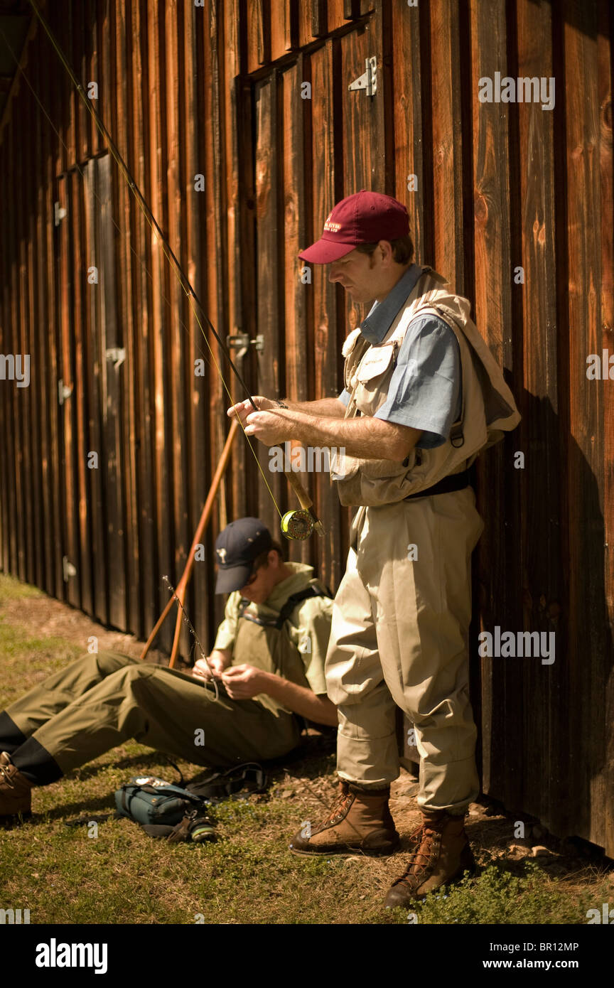 Men adjusting fishing rods Stock Photo