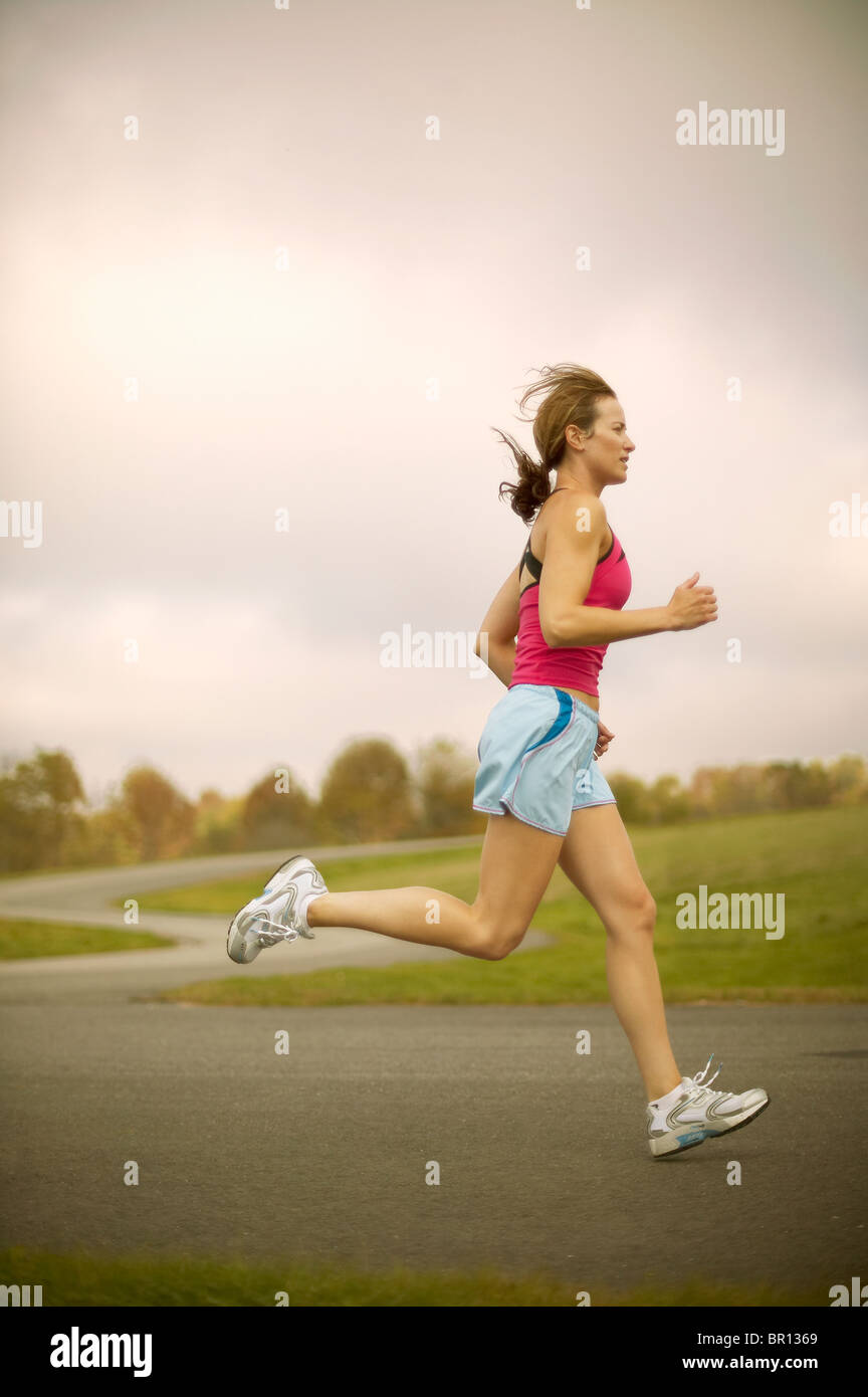 Woman jogging on path Stock Photo