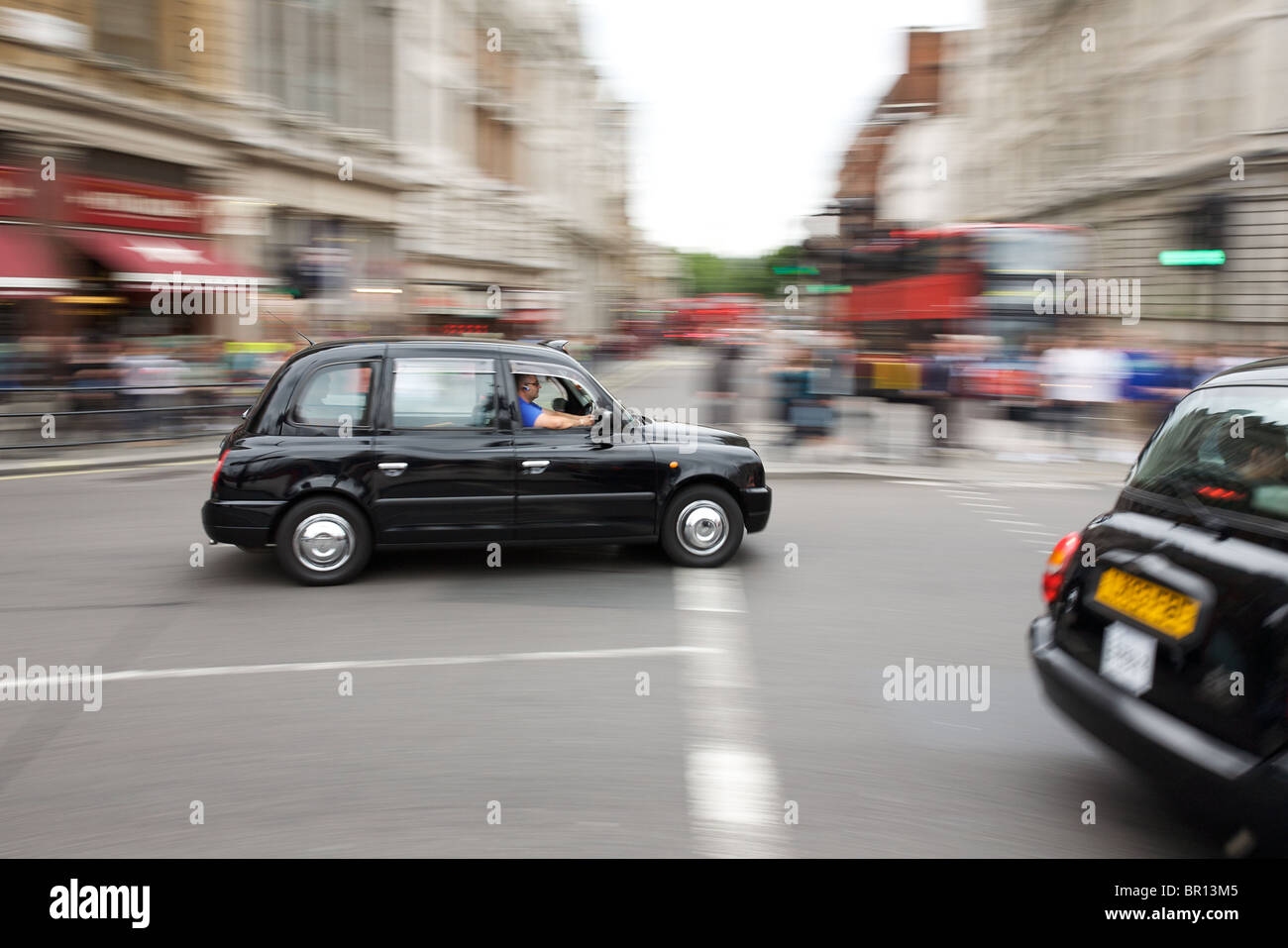 London taxi driving round Trafalgar Square, London Stock Photo