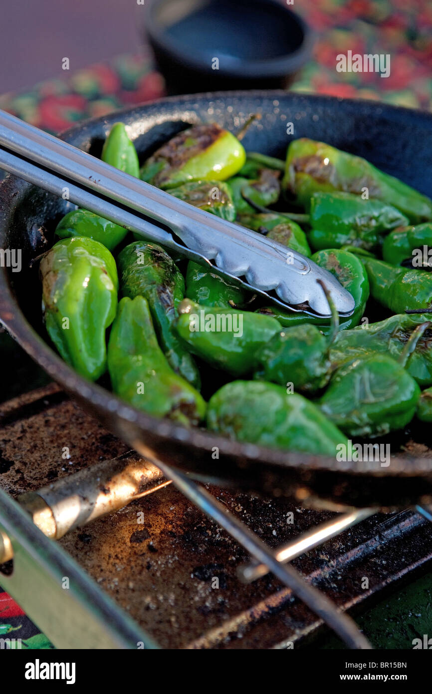 green chile roasting in a pan jalapeno pepper cook cooking fire hot
