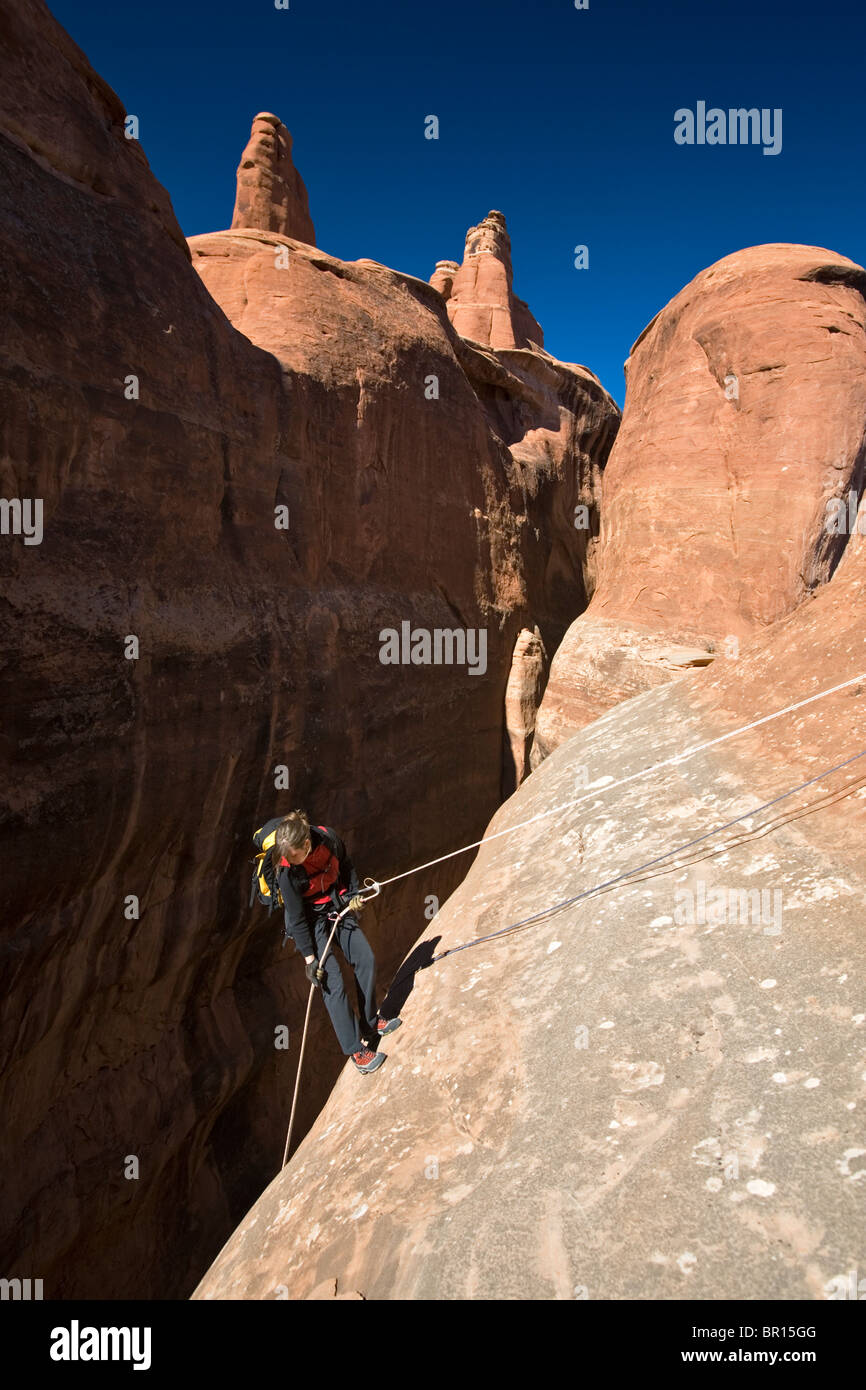A woman rappelling in Arches National Park, Moab, Utah Stock Photo - Alamy