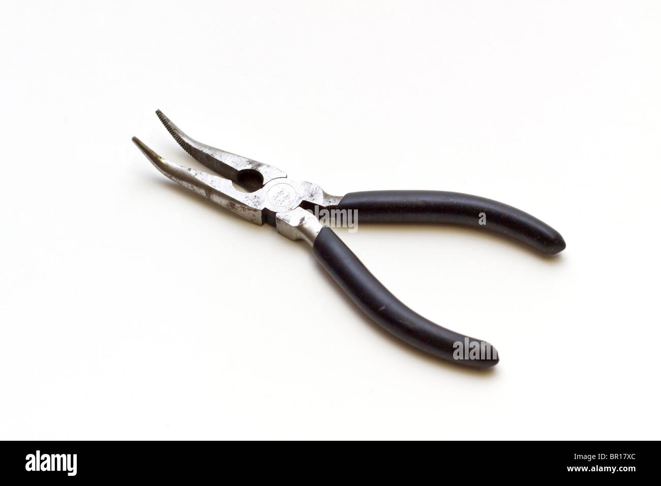Curved needle-nose pliers with a black insulated grip Stock Photo