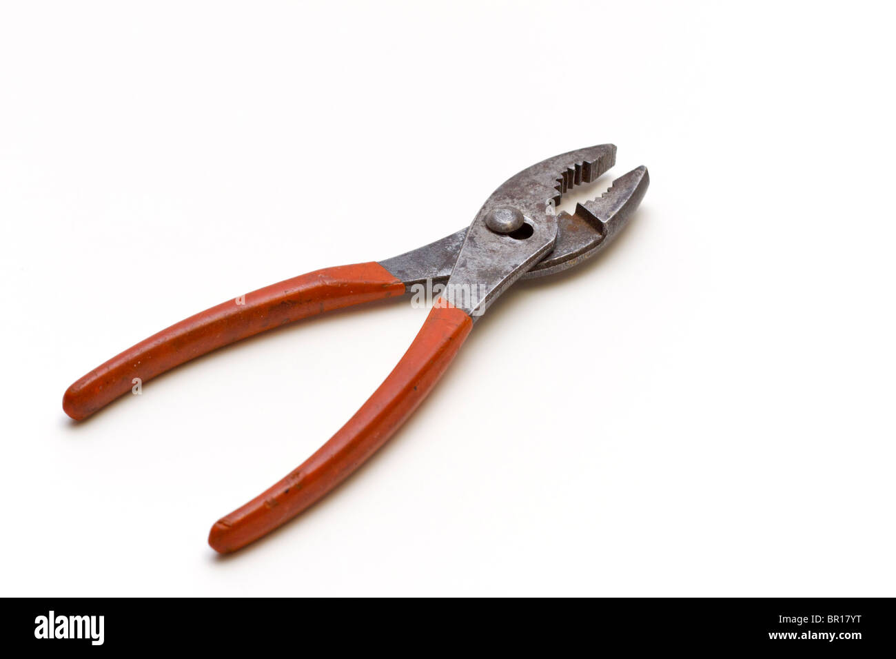 Adjustable pliers with an insulated orange plastic grip Stock Photo