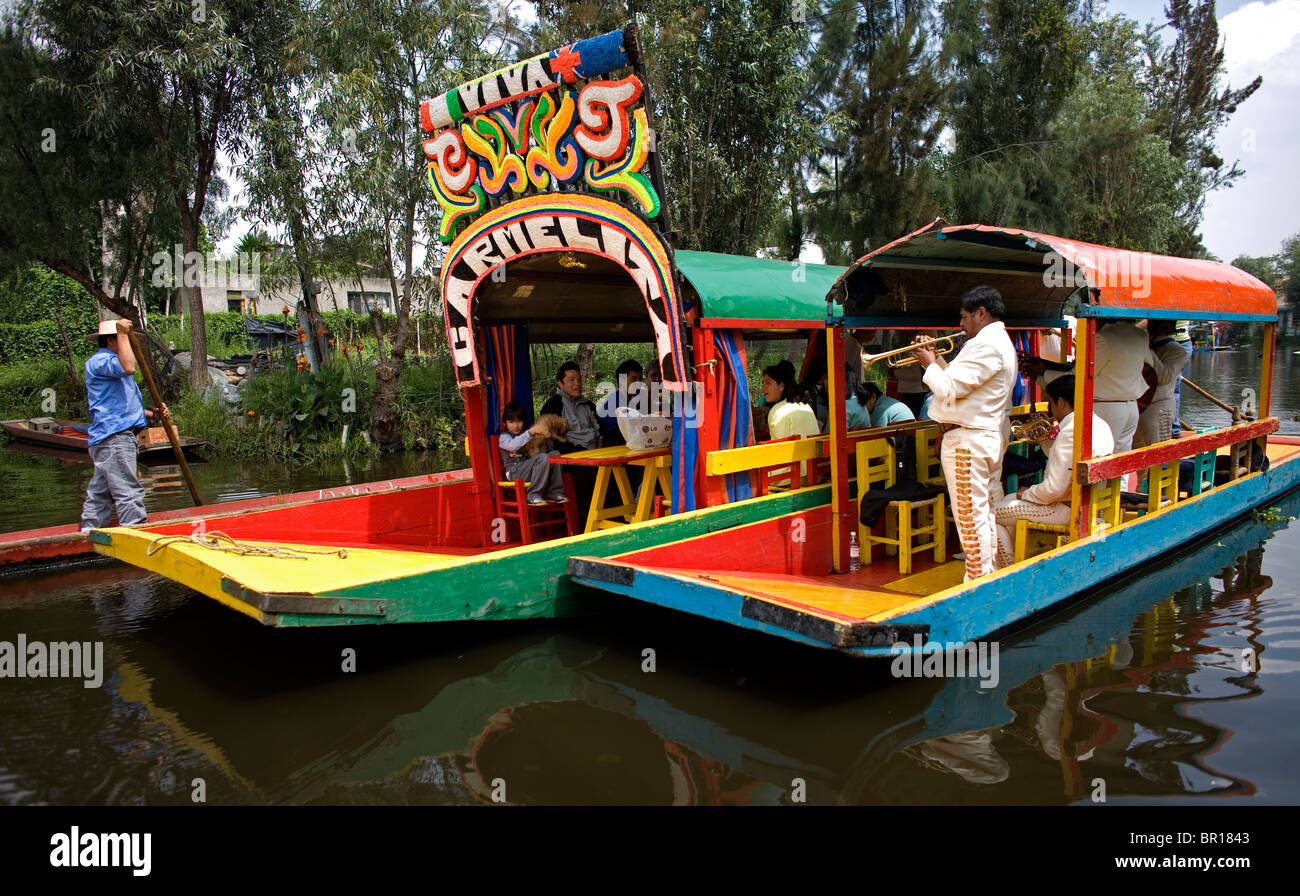 Mariachi musicians play Mexican songs to tourists in a boat through the