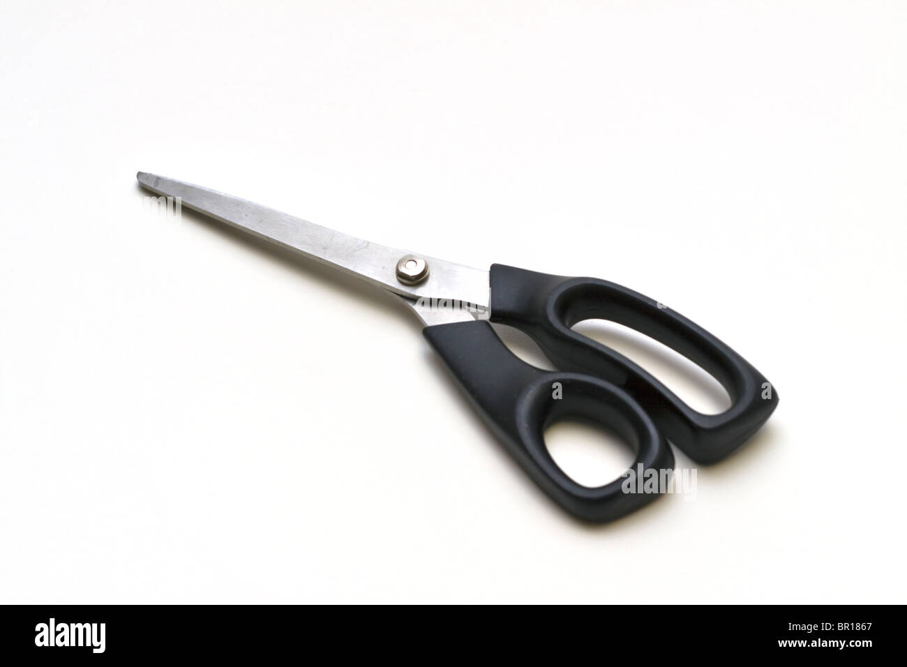 A pair of scissors with black plastic handles Stock Photo