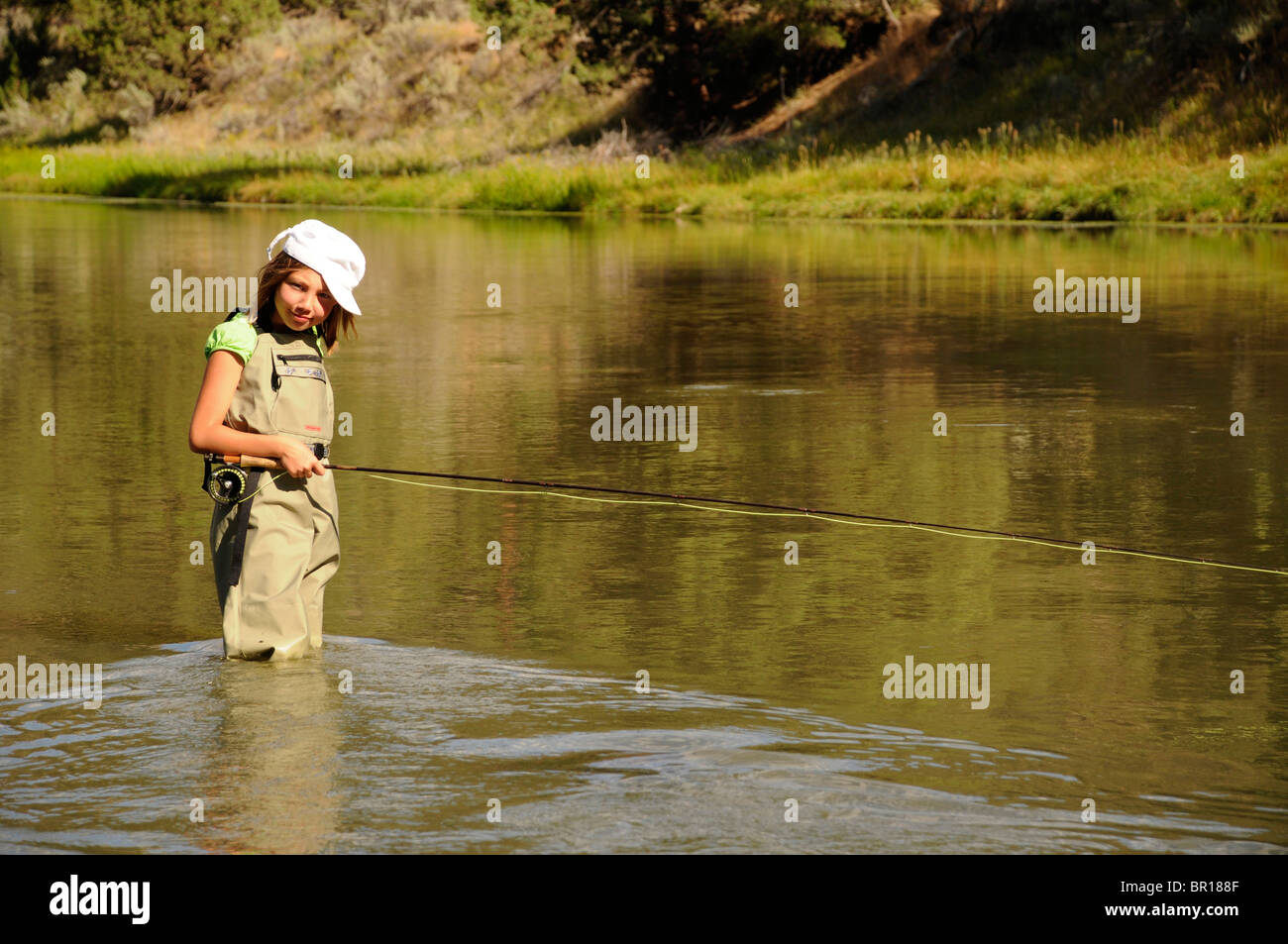 11 year old girl fly fishing in river near Bend, Oregon Stock