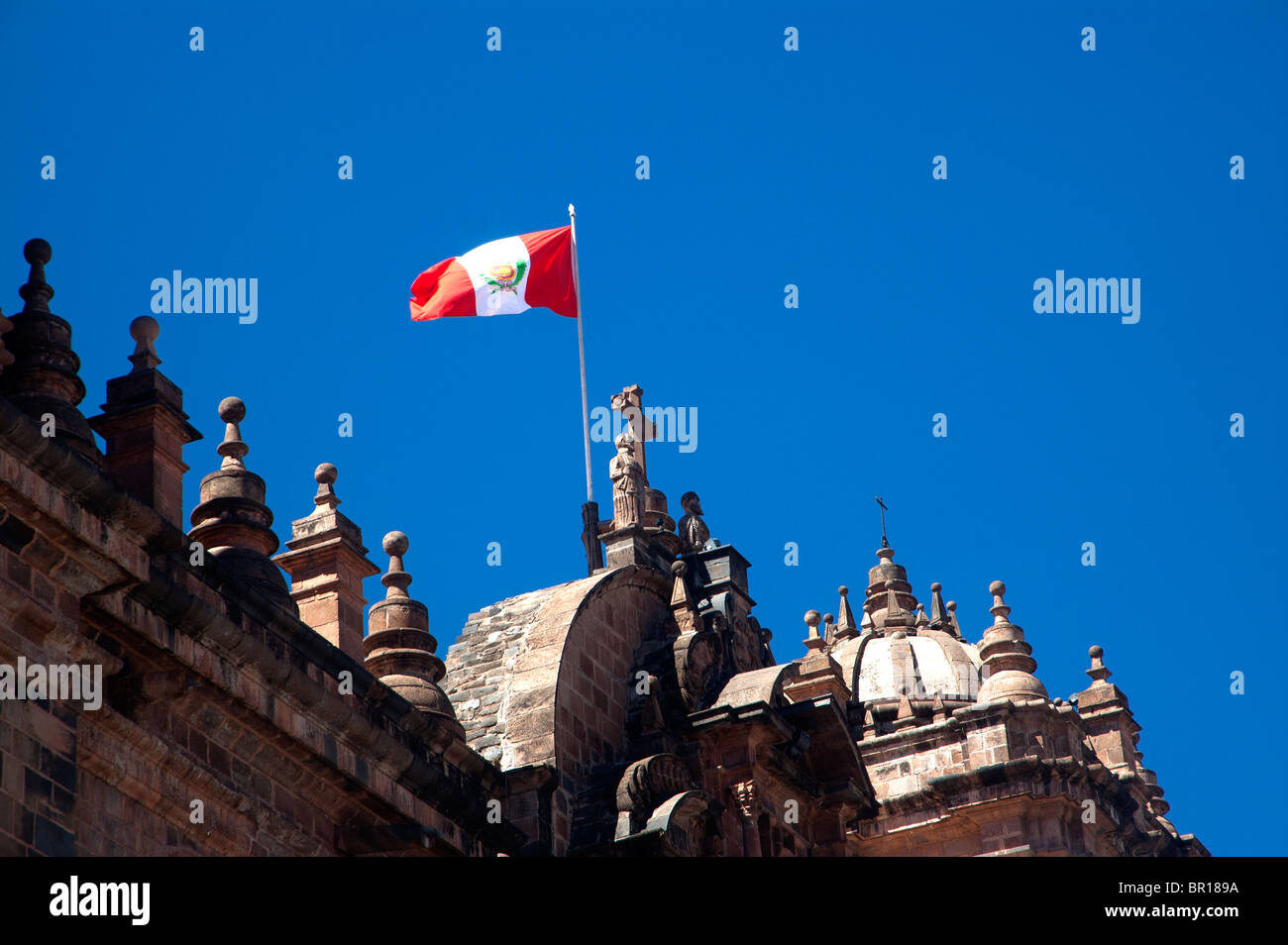 The Peruvian flag flies above the Cathedral, Plaza de Armas, Cusco, Peru. Stock Photo