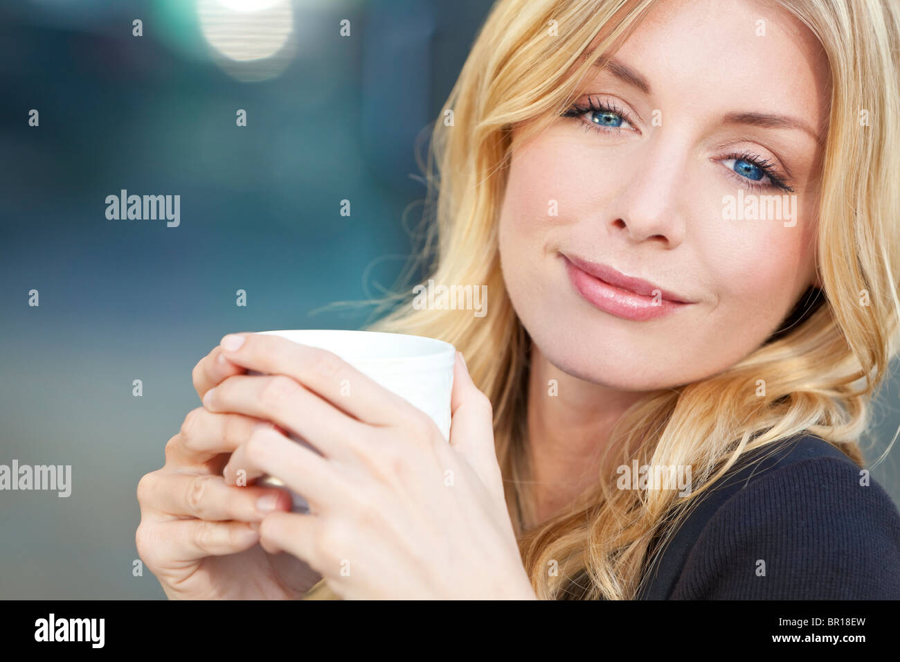 A Beautiful Smiling Young Woman With Blond Hair And Blue Eyes