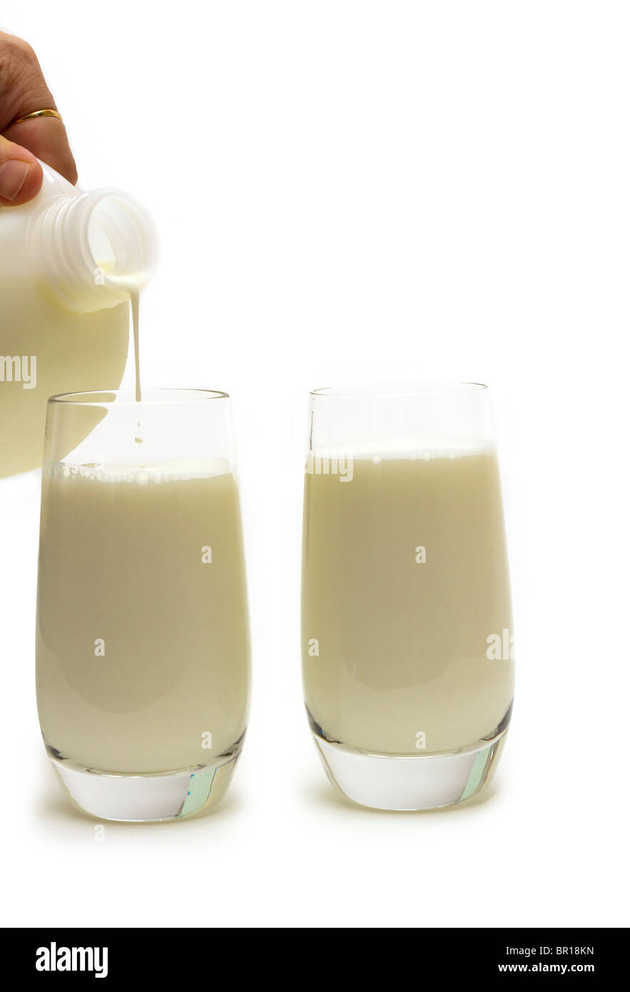 Pouring two glasses of milk from a plastic jug Stock Photo Alamy