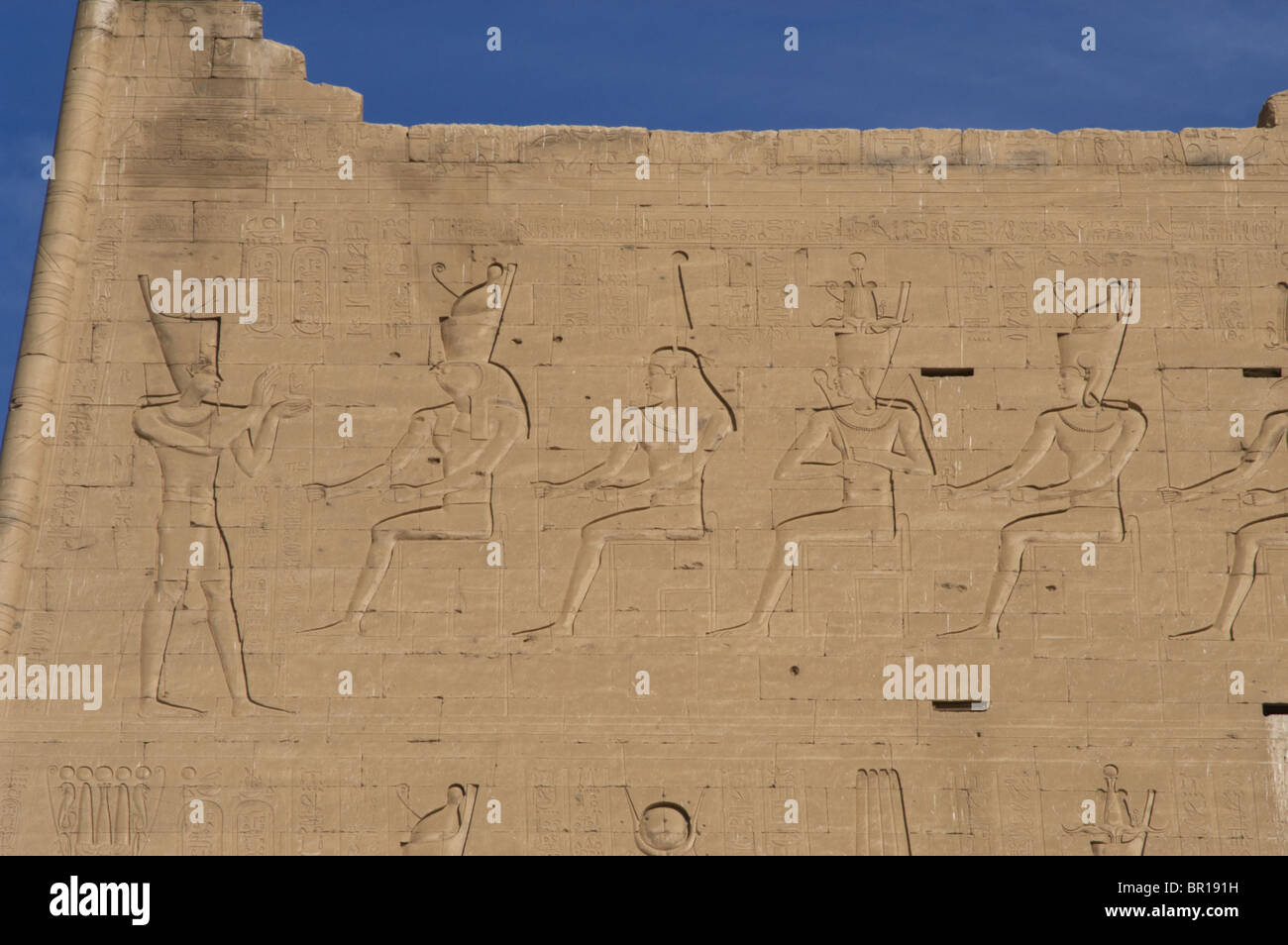 Temple of Horus. Pharaoh before gods. Main entrance. First pylon. Detail. Edfu. Egypt. Stock Photo