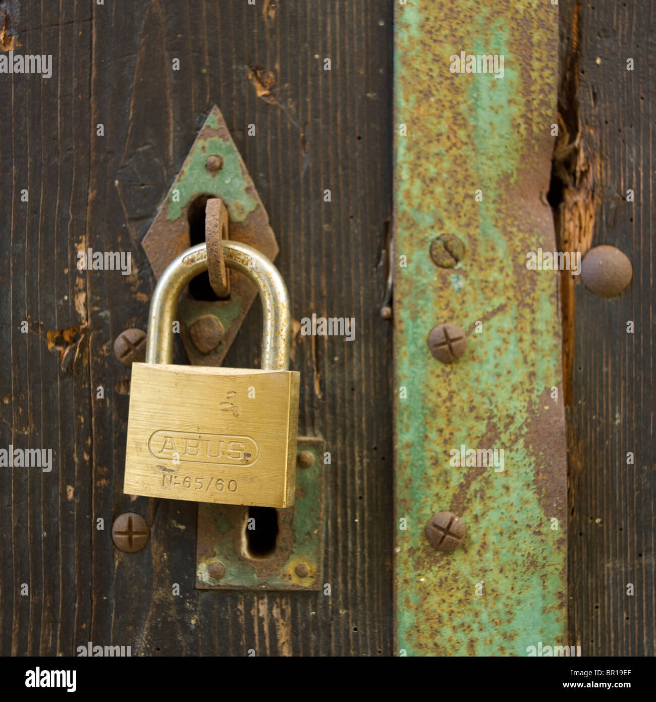 Wooden door and padlock Stock Photo