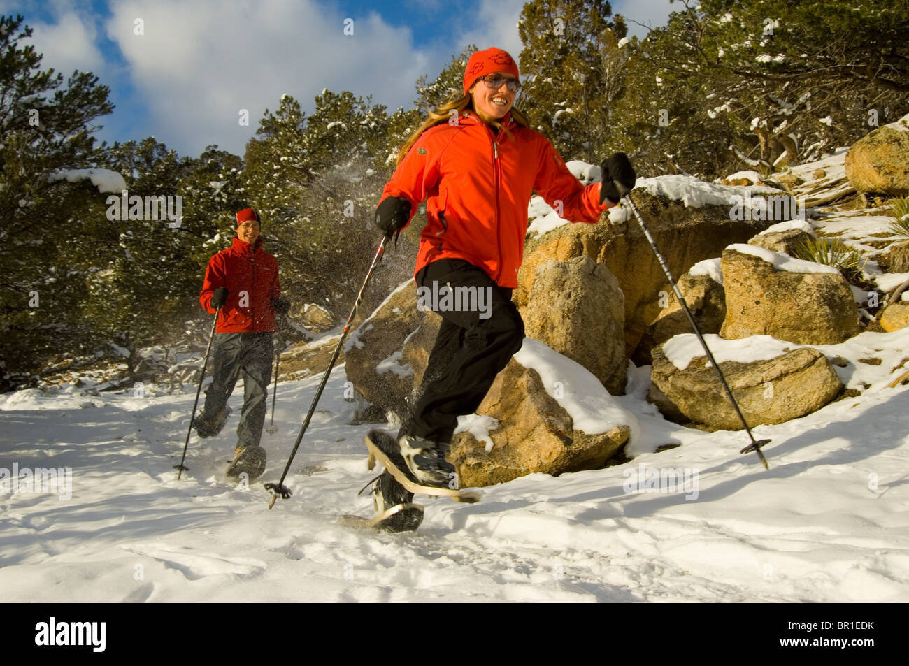 Man and Woman running on snowshoes, Ridgway Colorado Stock Photo