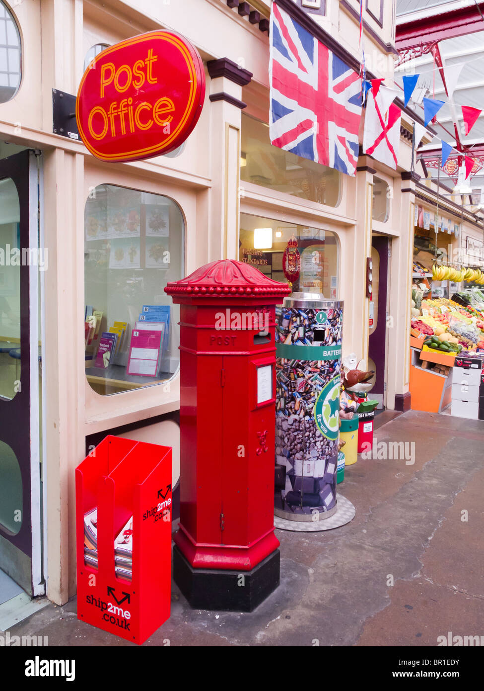 A hexagonal Victorian post box still in use at the Post Office in the covered market in St. Helier, Jersey. Stock Photo