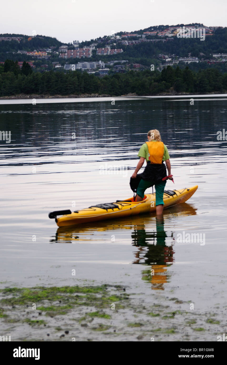 Woman in canoe in Bergen Norway Stock Photo