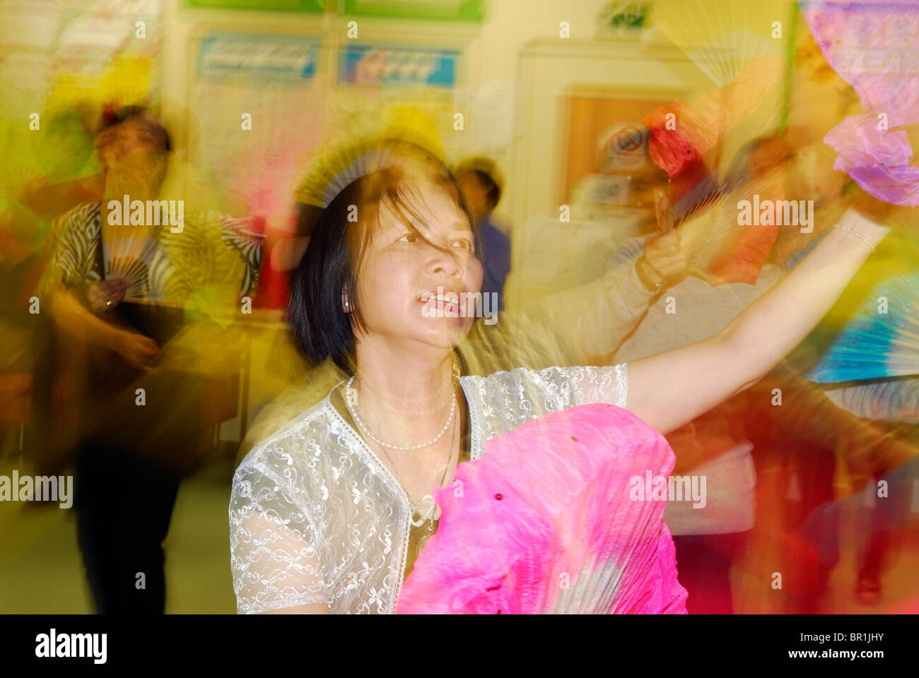Women doing traditional Chinese dancing routine at a Chinese Community Centre, London, UK. Stock Photo