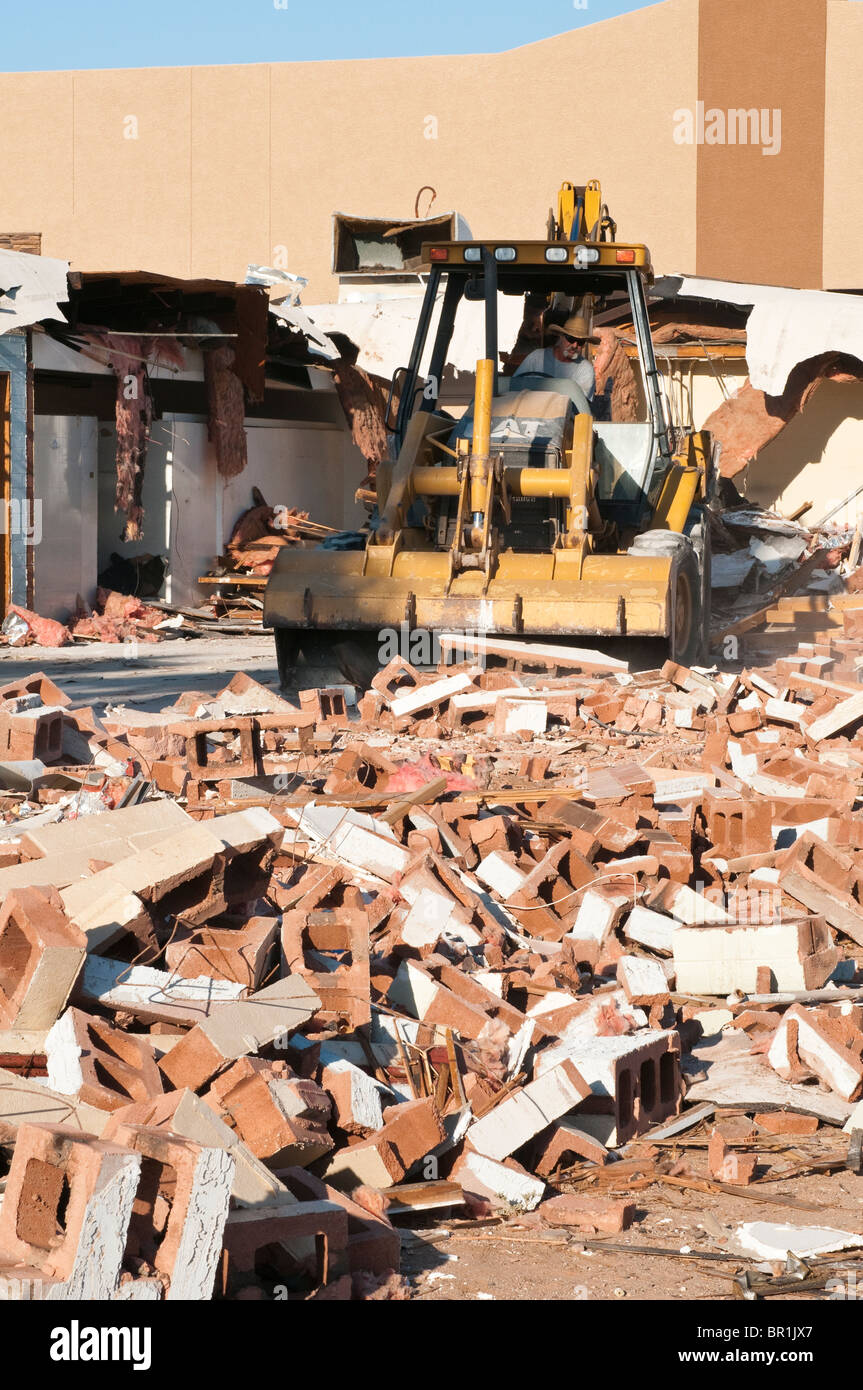 Material from an old commercial building that has been torn down is being cleared from the work site. Stock Photo