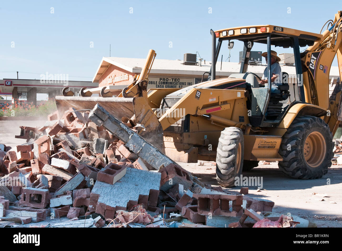 Material from an old commercial building that has been torn down is being cleared from the work site. Stock Photo