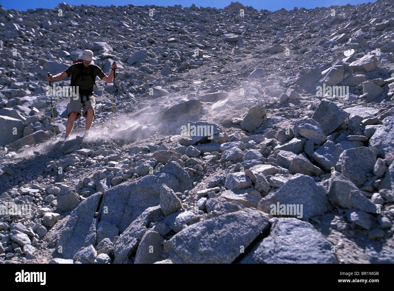Hiker sliding down boulder slope in Eastern Sierra Nevada mountains,  California Stock Photo - Alamy
