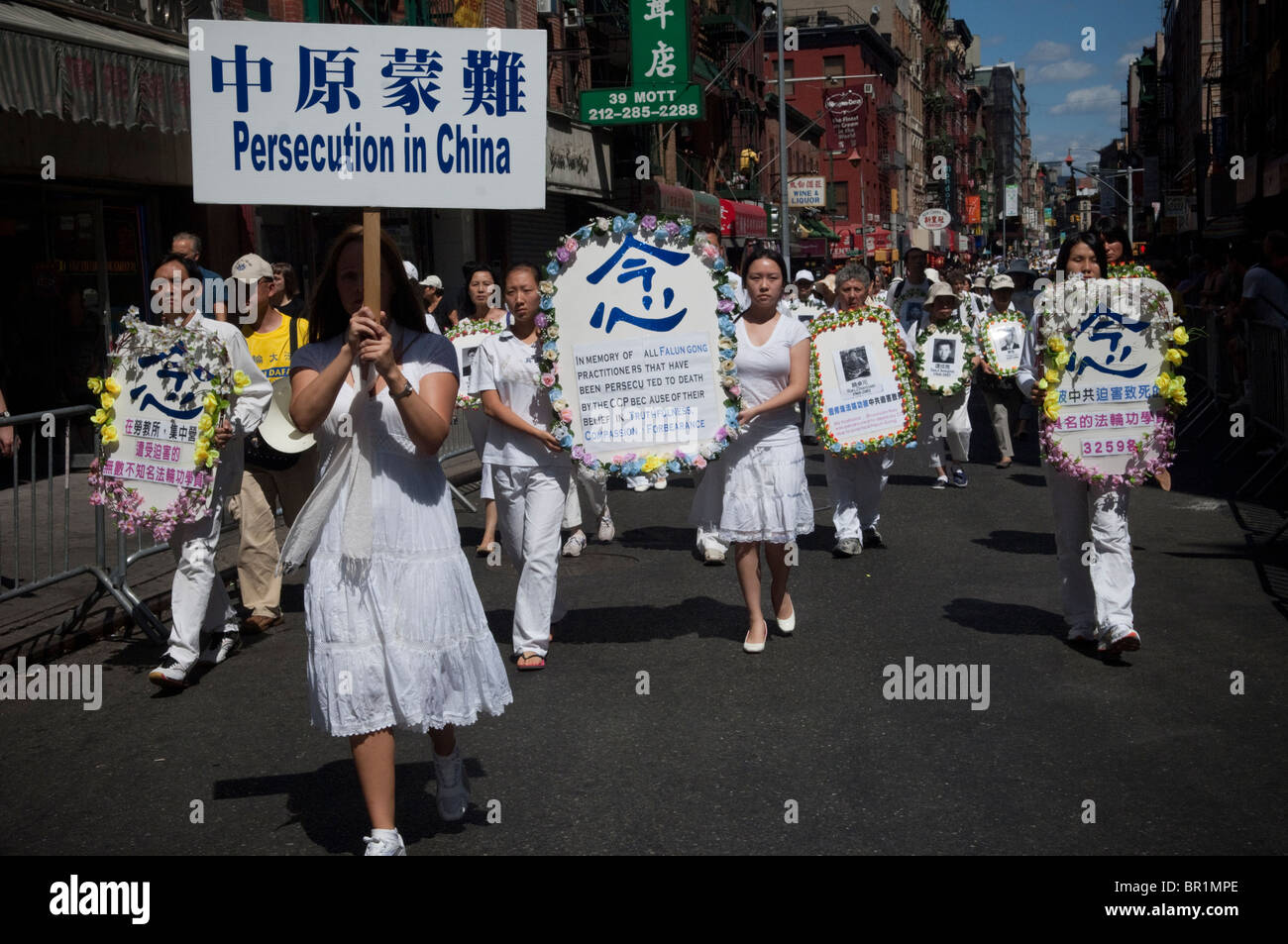 Members of Falun Dafa (Falun Gong) from around the world parade through the streets of Chinatown in New York Stock Photo