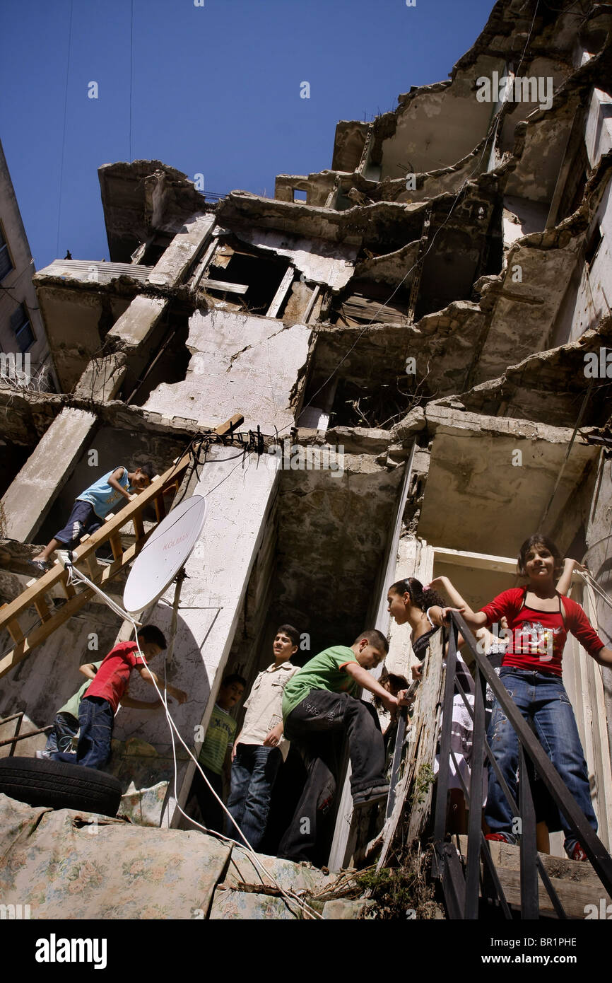 Palestinian kids in a Palestinian refugee camp in Beirut in Lebanon plays in a building which was destroyed in the 2006 bombings Stock Photo