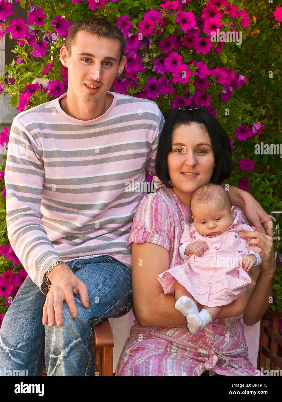 Young couple posing for portrait with baby france